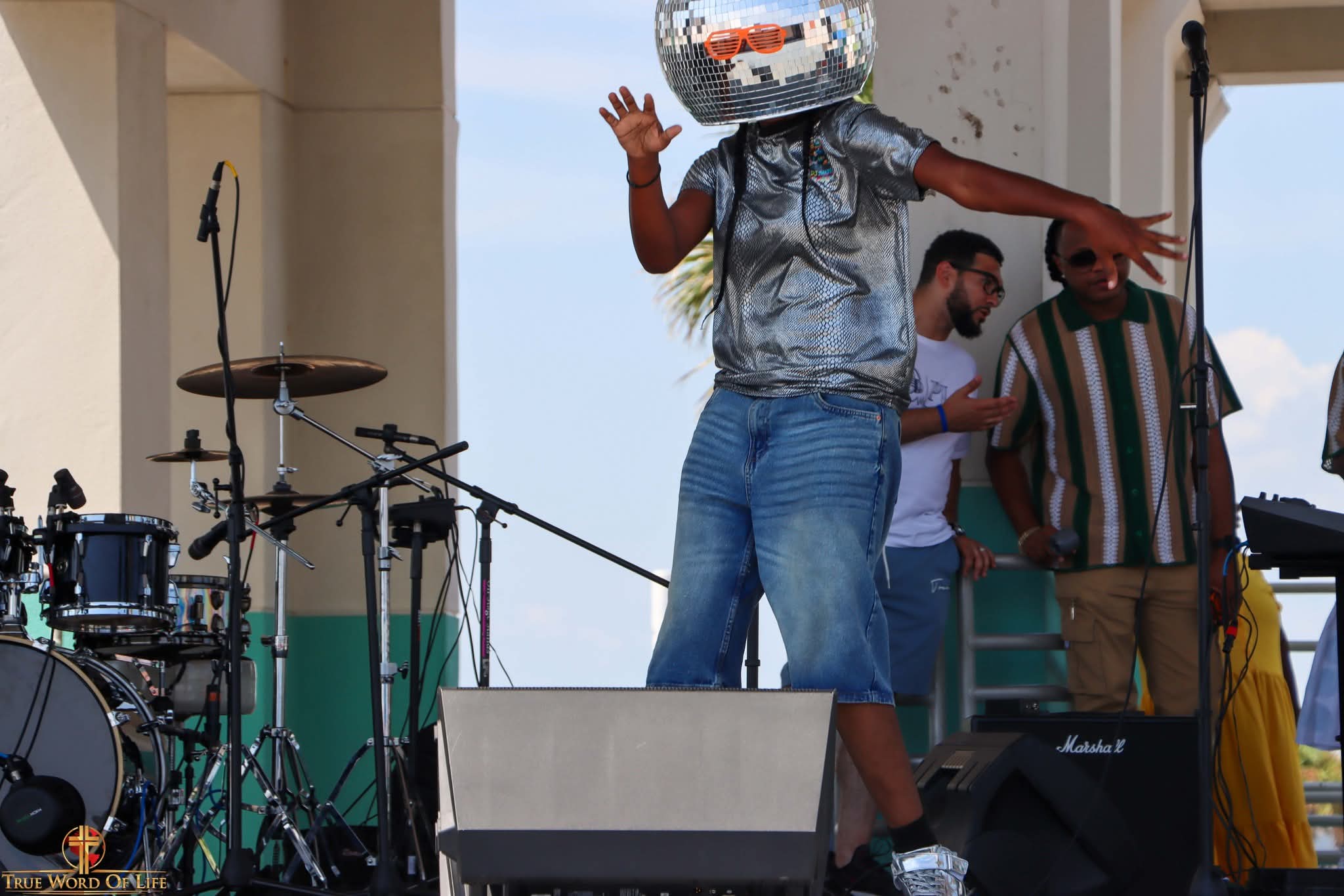 DJ Zmarie mid-performance, surrounded by musicians